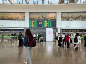 Interior de un aeropuerto con pantallas de información de vuelos