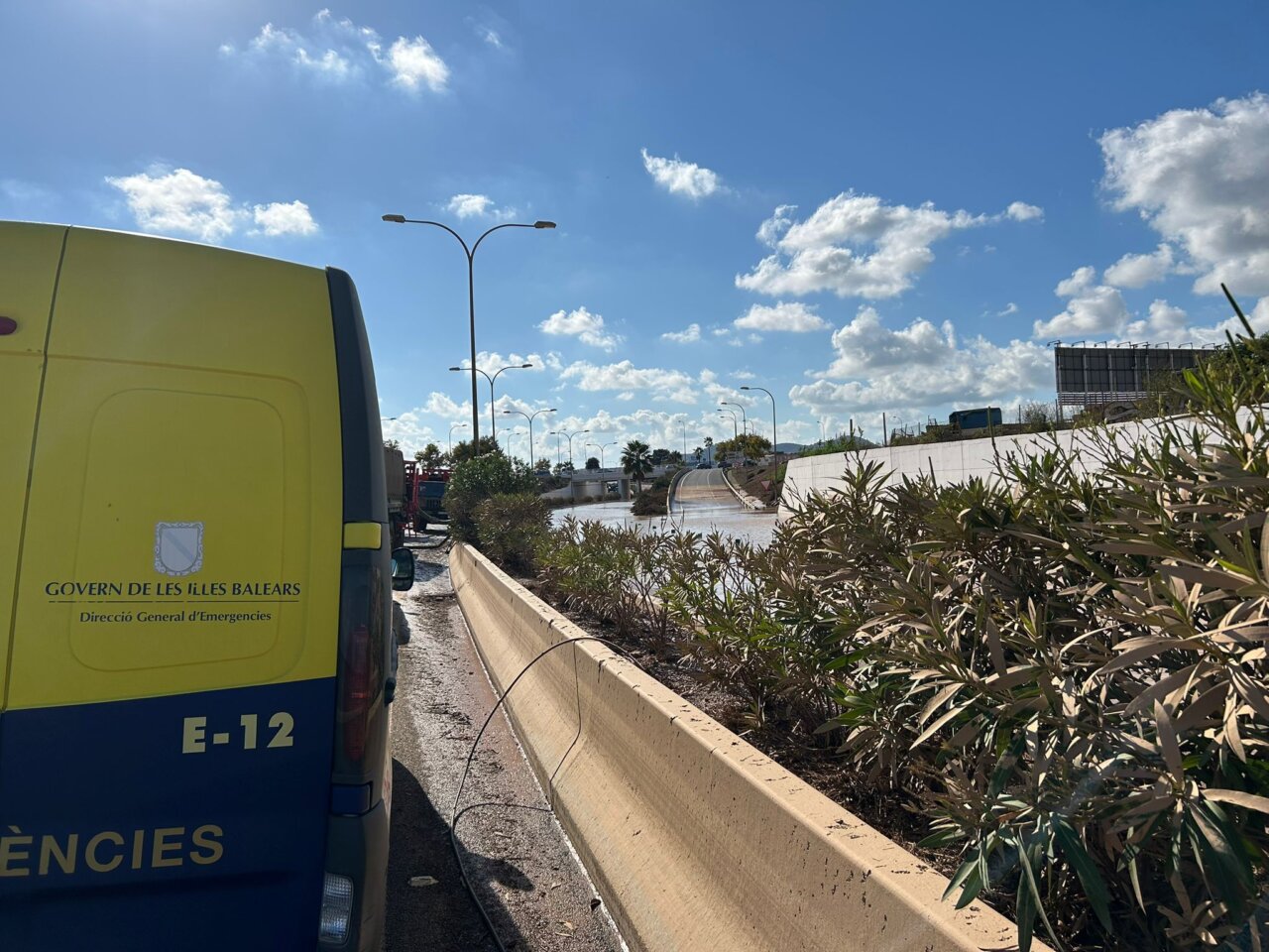 Trabajo en la carretera del aeropuerto de Ibiza con vegetación y cielo azul