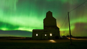 Auroras boreales iluminando el cielo sobre un edificio antiguo
