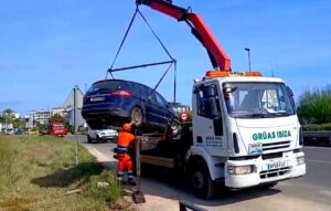 Coche siendo retirado por grúa tras inundación en Ibiza