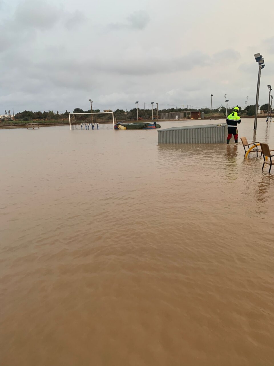 Campo inundado con un hombre en un entorno de tormenta en Formentera