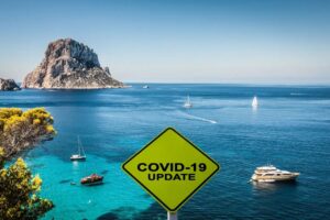 Vista de Ibiza con señal de actualización sobre COVID-19