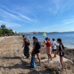 Grupo de jóvenes voluntarios limpiando la playa de Ibiza