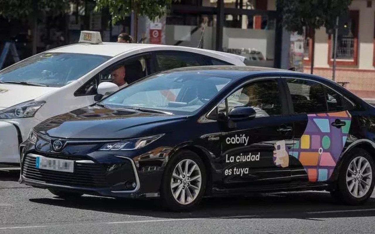Taxi y vehículo de VTC estacionados en la calle